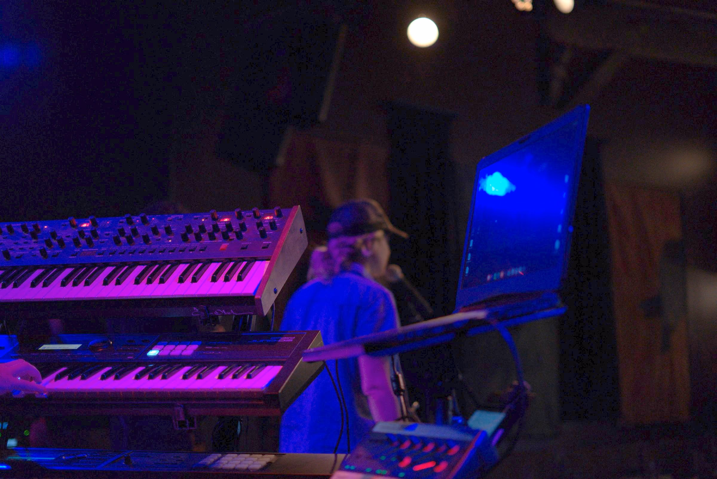 Keyboard rig lit purple and blue between songs